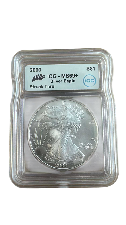 2000 Silver Eagle Struck Thru Error – ICG MS69+ Austin Hutto Signature - CoinsTV